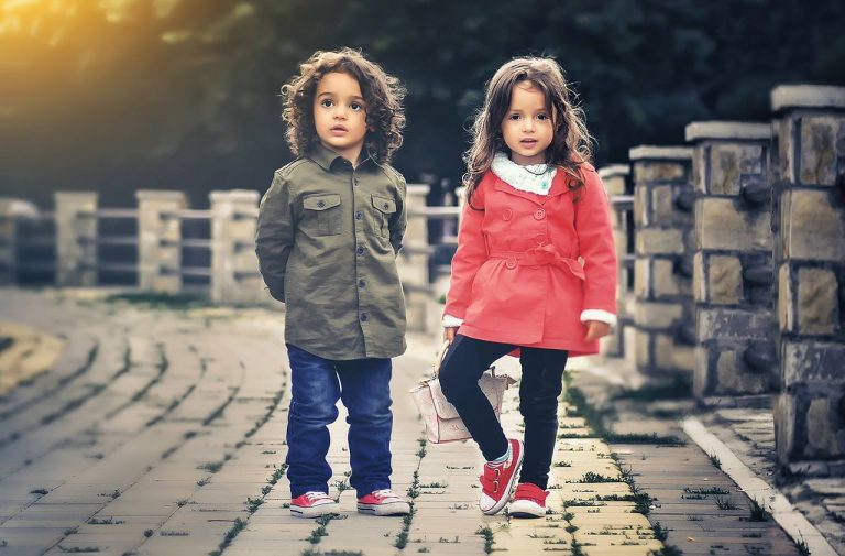 Siblings standing on a bridge