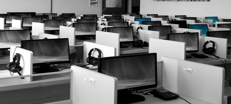 Many computers in cubicles