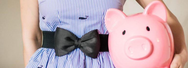 Woman holding a pink piggy bank