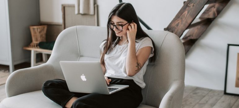 Woman using laptop in a cozy living room