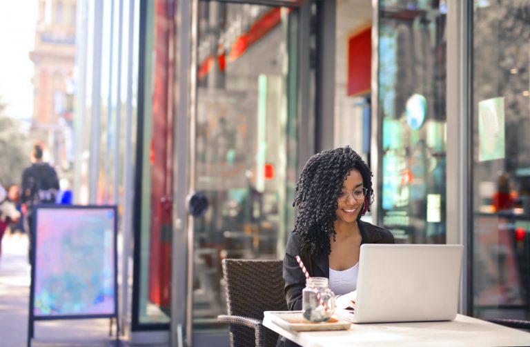 a woman sitting on her laptop writing something