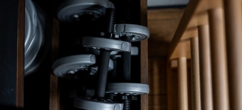 a stack of weights inside a wooden box as a way of relocating gym equipment