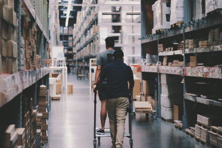 Two men going around a warehouse