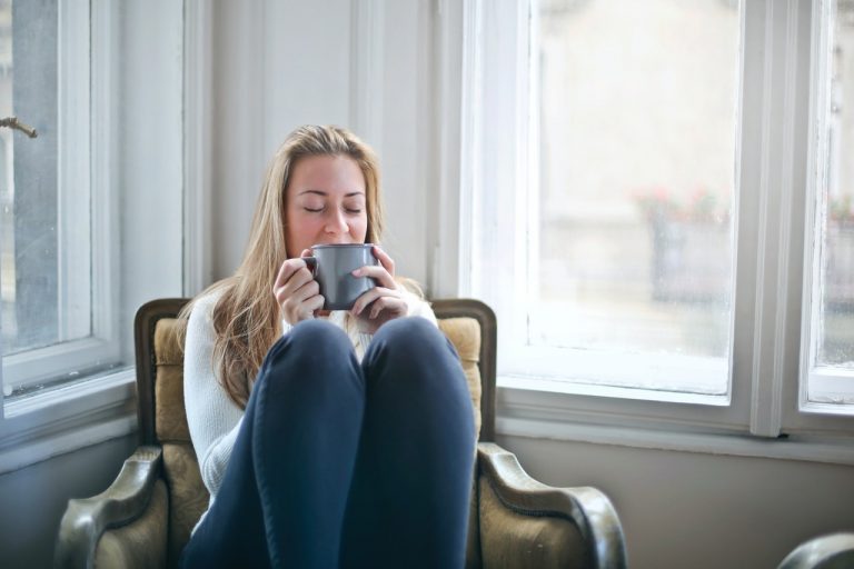 A woman relaxing and drinking tea.