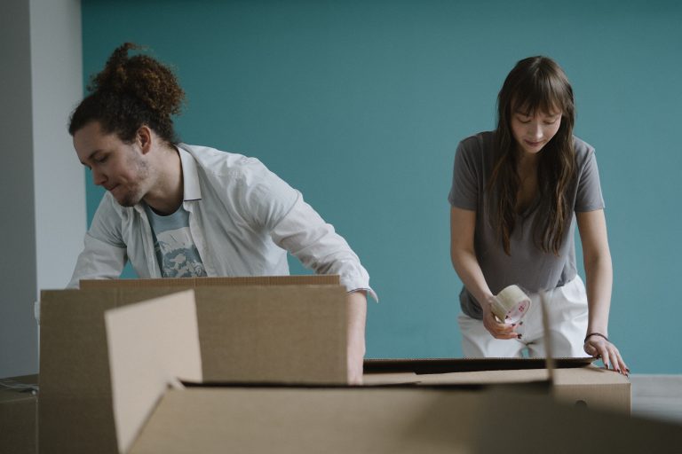 two people packing for moving on understanding moving company liability