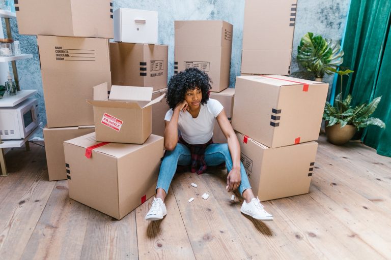 Woman next to cardboard boxes
