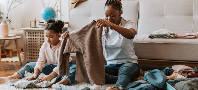 Woman and child holding clothes together