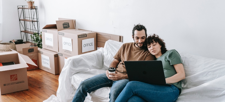 A couple sitting on a couch before moving into a high-rise building in Toronto.