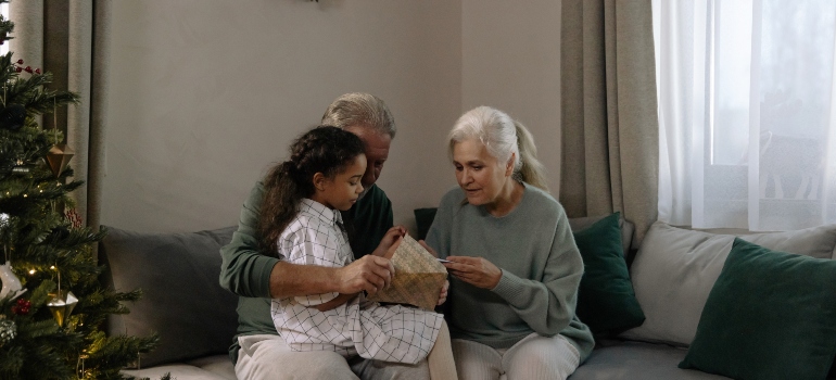 grandparents sitting with their granddaughter after hiring senior movers Ottawa