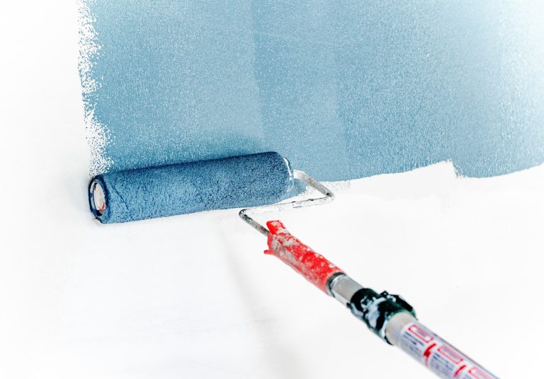 Picture of a paint roler on a white wall