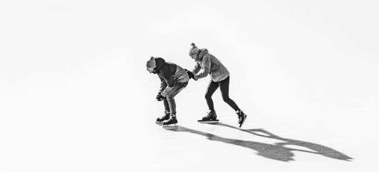 Two people having fun while ice skating