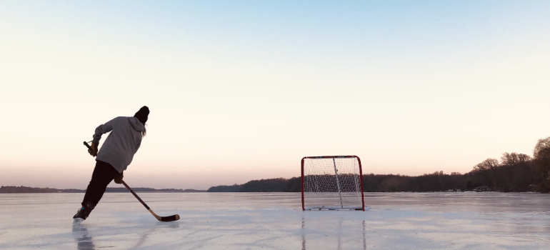 A person practicing hockey on ice