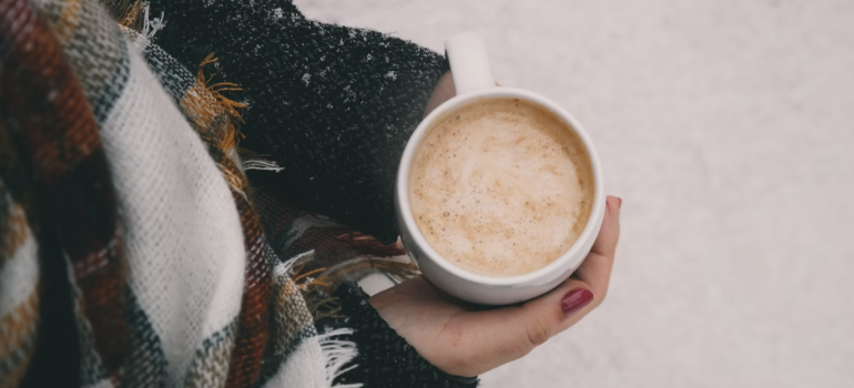 Warming up with a cup of hot coffee during winter