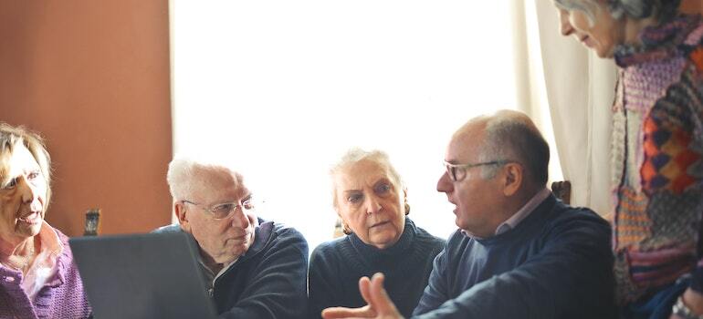 A group of seniors talking and sitting at a table