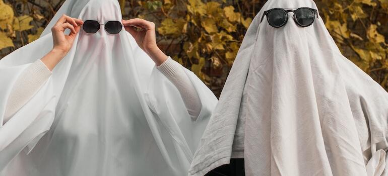 Two people dressed up as ghosts