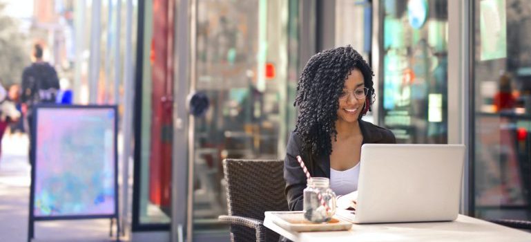 Woman working on her laptop in one of the safest Ottawa neighborhoods to move to