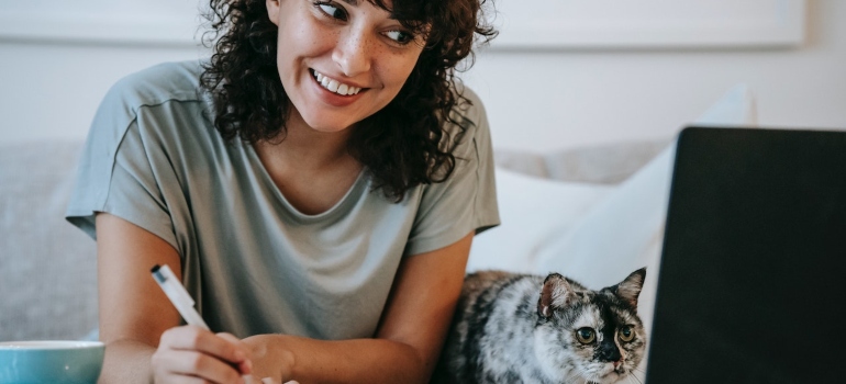Picture of a person reading Winchester moving guides for families with her cat 