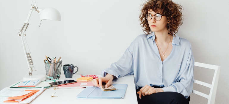 a woman sitting and thinking about budgeting tips for students in Ottawa