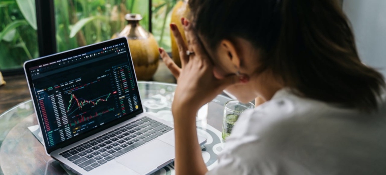 a young girl thinking about budgeting tips on her laptop