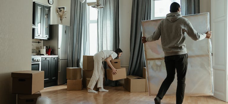 a couple packing while discussing the best time of year to move their business in Ottawa