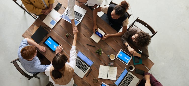 a group of people sitting at a desk