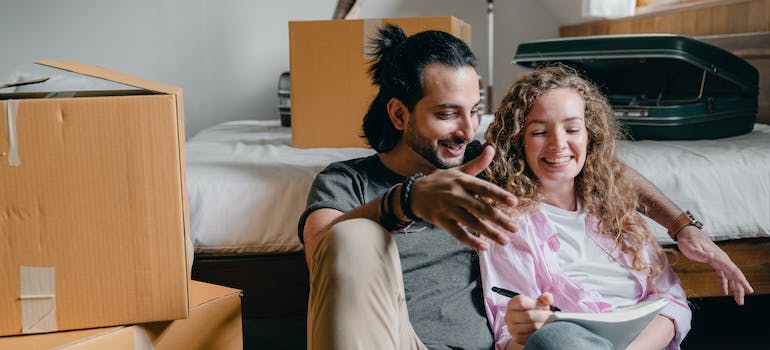 A couple reading the room by room packing guide