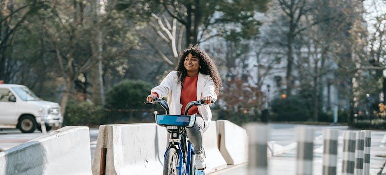 a woman riding a bike thinking about the best time of year to move her business in Ottawa