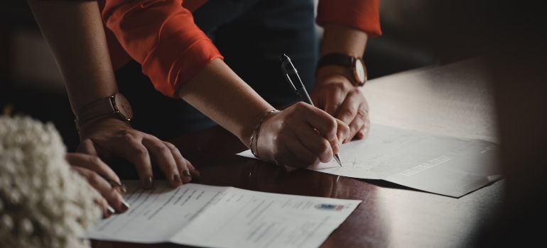 Picture of a person signing a contract