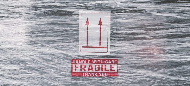Fragile sign on top of plastic wrap