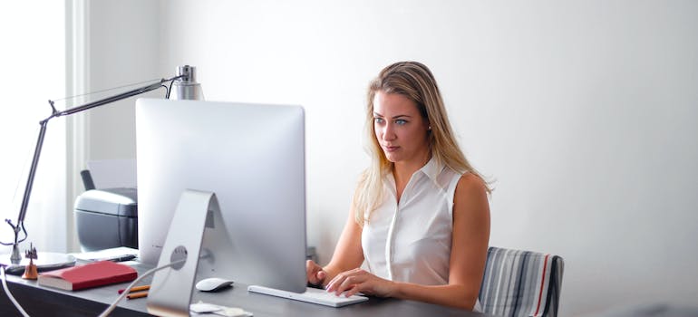 A woman using her computer to research the tips for selling your Ottawa home