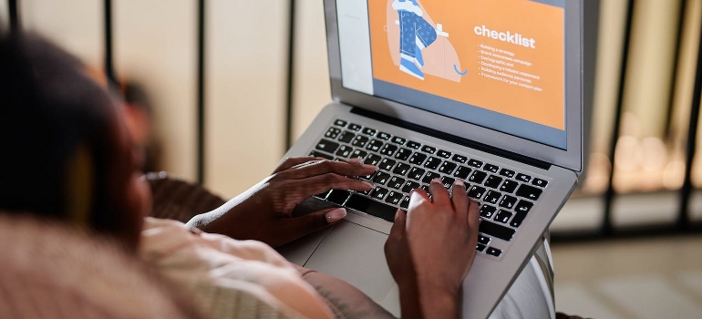 A person is browsing a checklist to prepare your appliances for relocation.