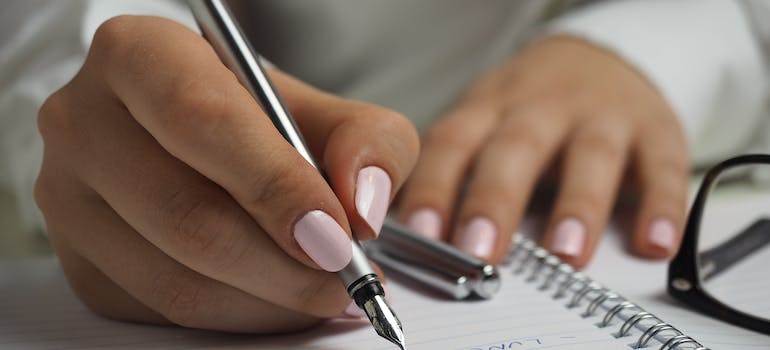a person making a detailed inventory list before moving
