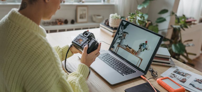 A professional photographer looking at her camera