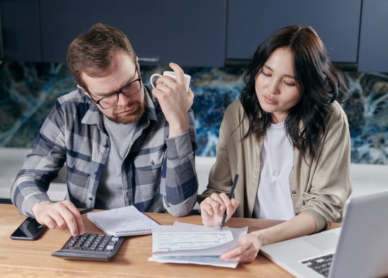 Couple calculating unexpected costs of moving to a new home in Ottawa