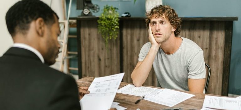Person speaking to a professional about the unexpected costs of moving to a new home in Ottawa