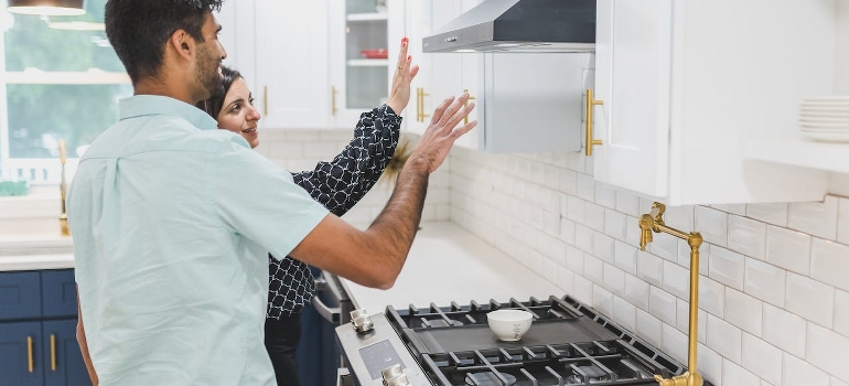 A couple planning how to move appliances.