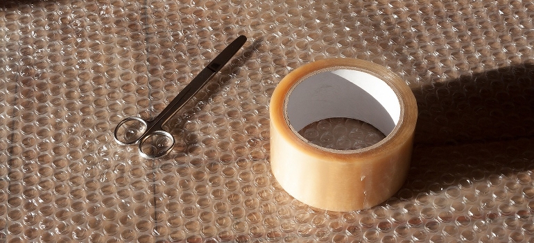 Bubble wrap, scissors, and duct tape - items needed to prepare your appliances for relocation.