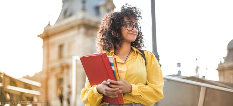 A woman holding books
