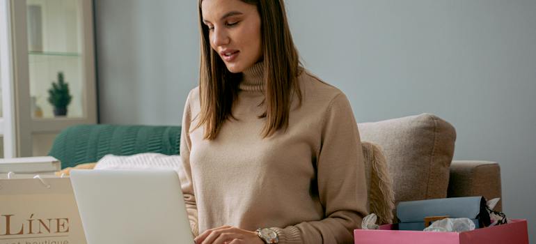 a woman reading on a laptop about renting vs. owning in Ottawa in 2024