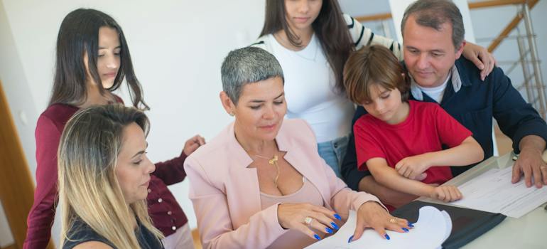 a group of people looking at a plan of home