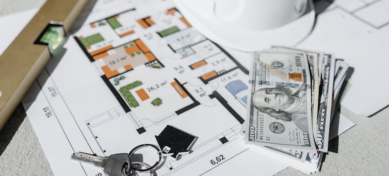 money and keys on a multi colored surface