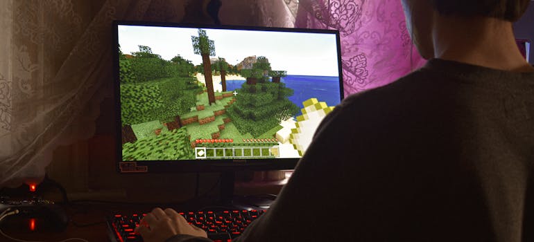a boy playing minecraft after relocate your gaming room with ease