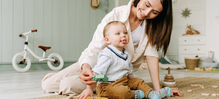 A mother and child sitting on the floor