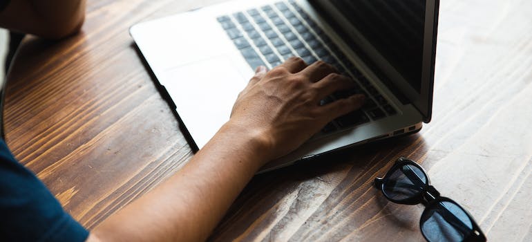 homeowner using laptop to control smart home devices