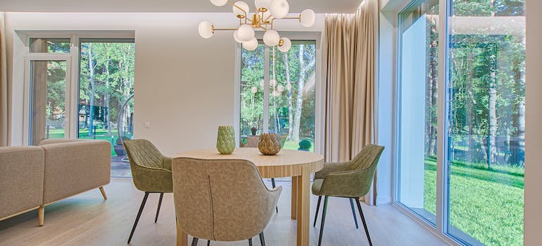 a wide light living room with dining table
