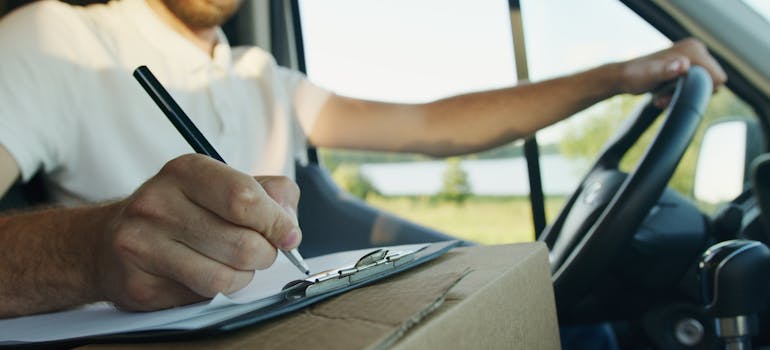 a man writing down questions to ask your ottawa movers