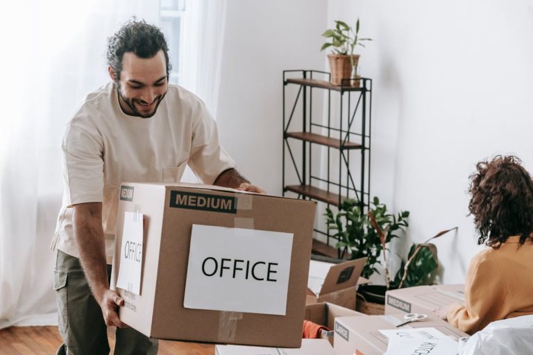 Men carrying brown box even though DIY moves aren't worth the hassle