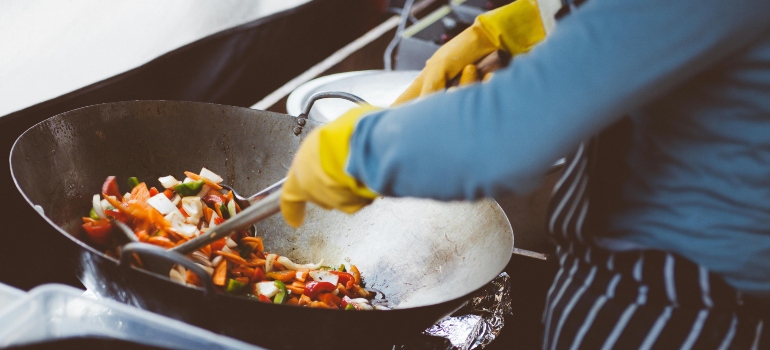 Person Cooking on Stainless Steel Cooking Pot