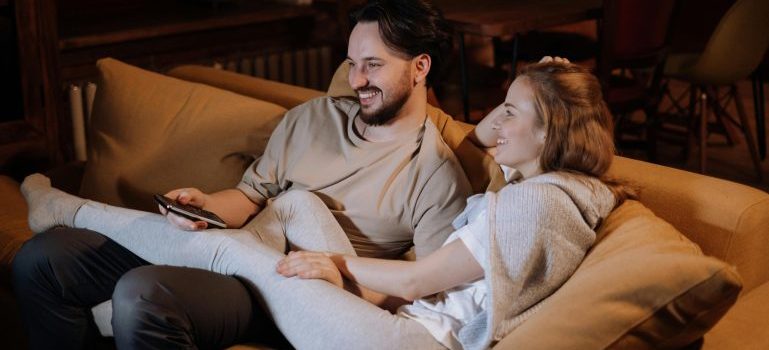 Couple sitting on the couch and laugjing