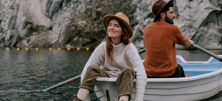 Couple on a boat looking at the nature around the water
